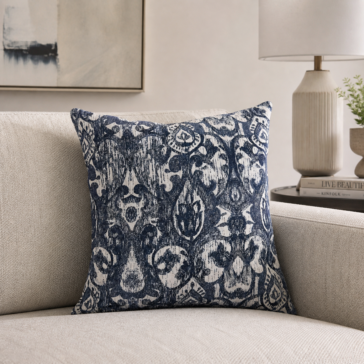Blue ikat throw pillow covers styled on a sofa in a modern living room with navy and ivory decorative pillow design by Design 59 Furniture